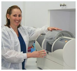 Yuliet, dental assistant working on a CEREC machine